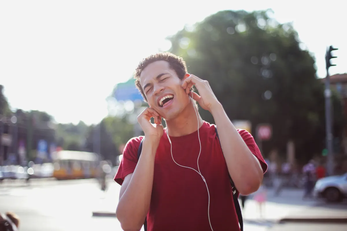 Student singing along to his favourite song with headphones on